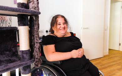 A woman in a wheelchair smiling